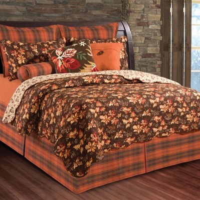 The luxury of rustic charm unfolds with this unique leaf print ensemble.
The scalloped edged quilt has rich autumn shades of terra cotta, russet, tan and beige on a rich chocolate ground, reversing to a stylized floral on a tan ground