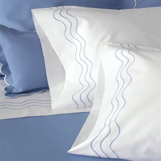 Serena Bed Linens feature white percale sheeting with three undulating rows of pearl stitching detail in a variety of colors.